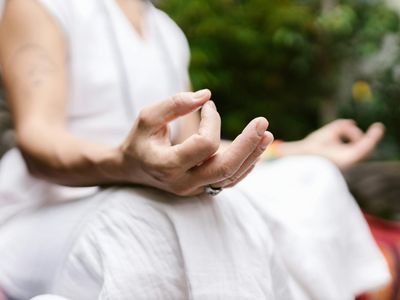 Detailed shot of hands in a mudra position during meditation.